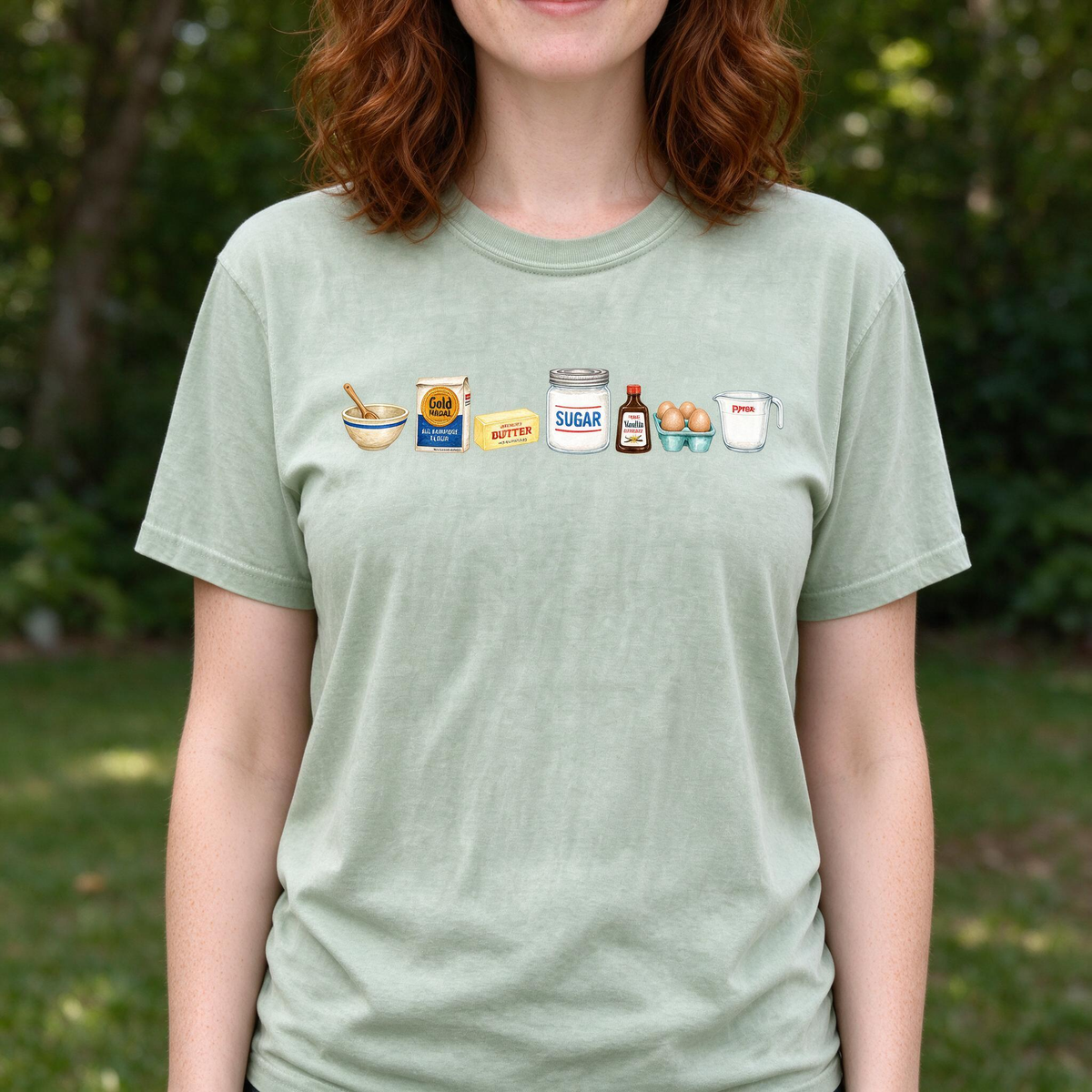 Model wearing the Baking Ingredients comfort colors tee in Bay