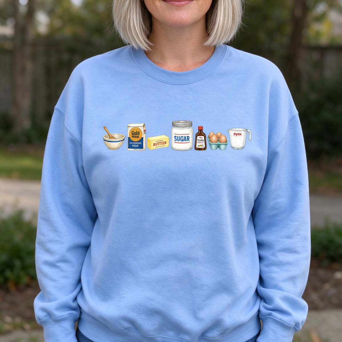 Model wearing the Baking Ingredients sweatshirt in Carolina Blue