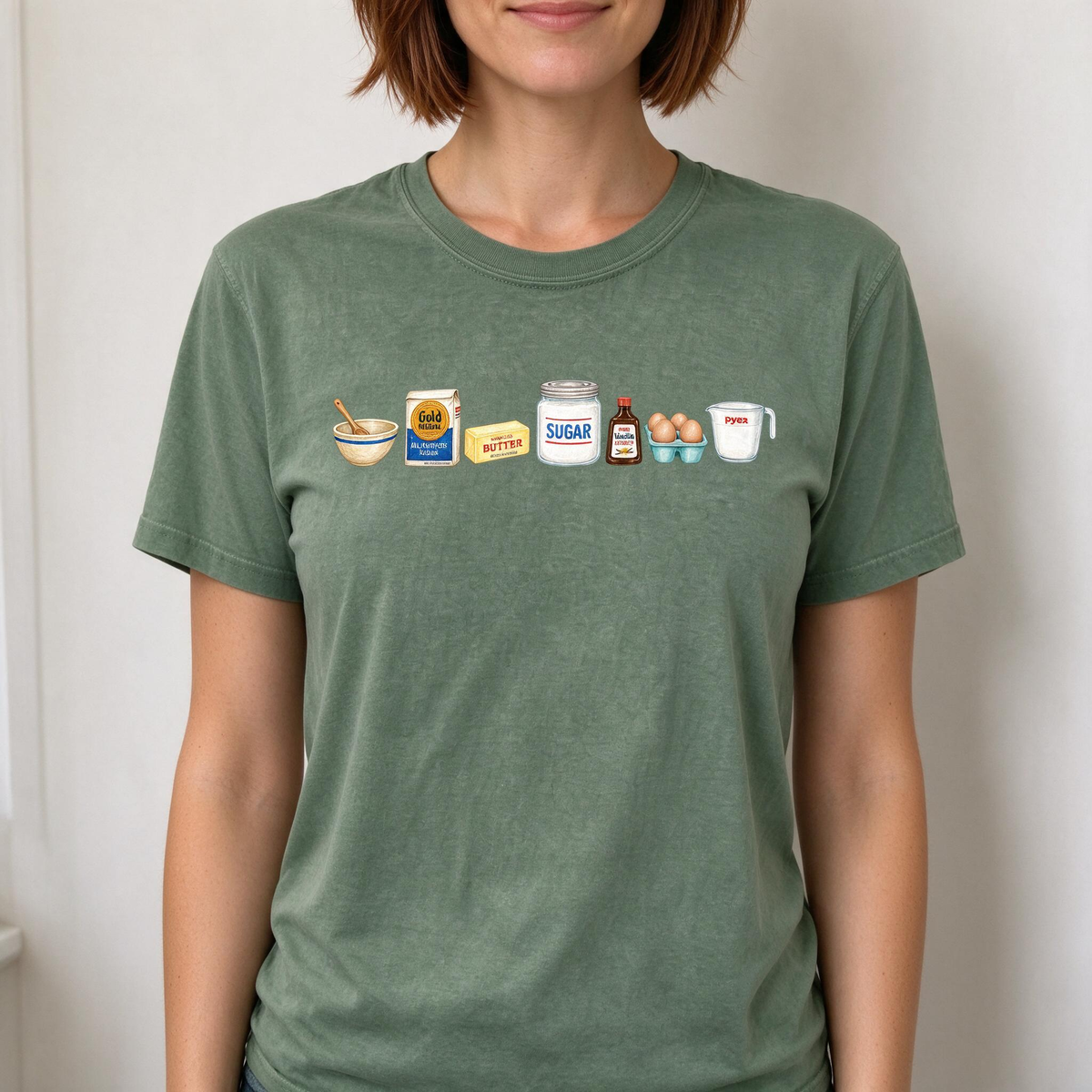Model wearing the Baking Ingredients comfort colors tee in Moss