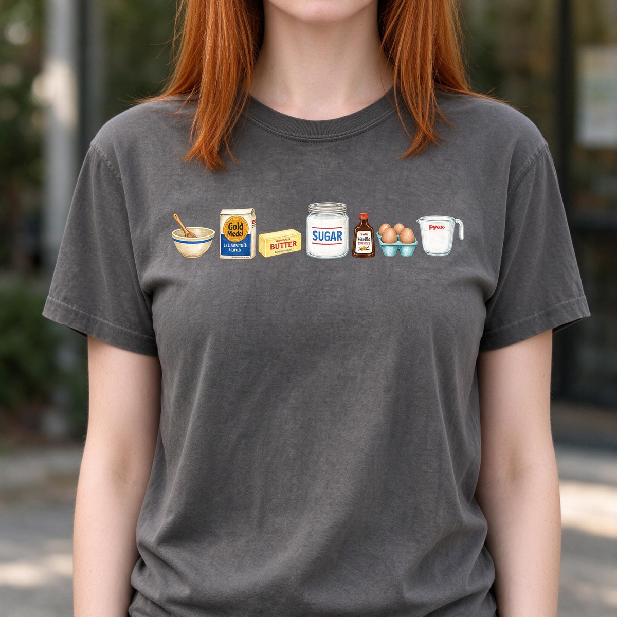 Model wearing the Baking Ingredients comfort colors tee in Pepper, lifestyle image 1