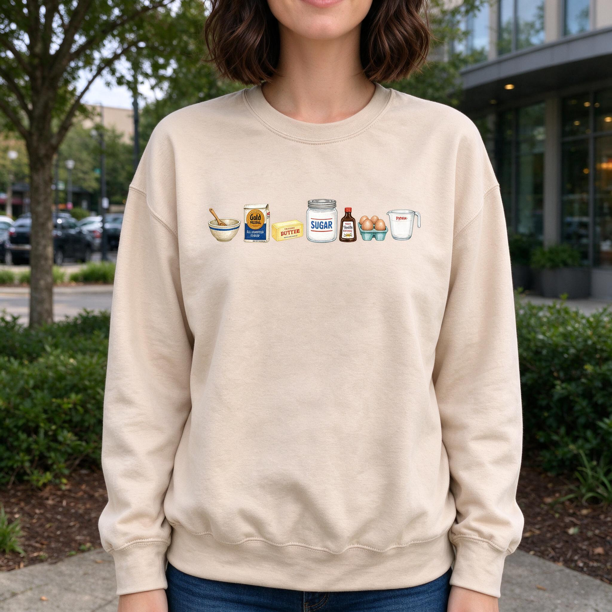 Model wearing the Baking Ingredients sweatshirt in Sand