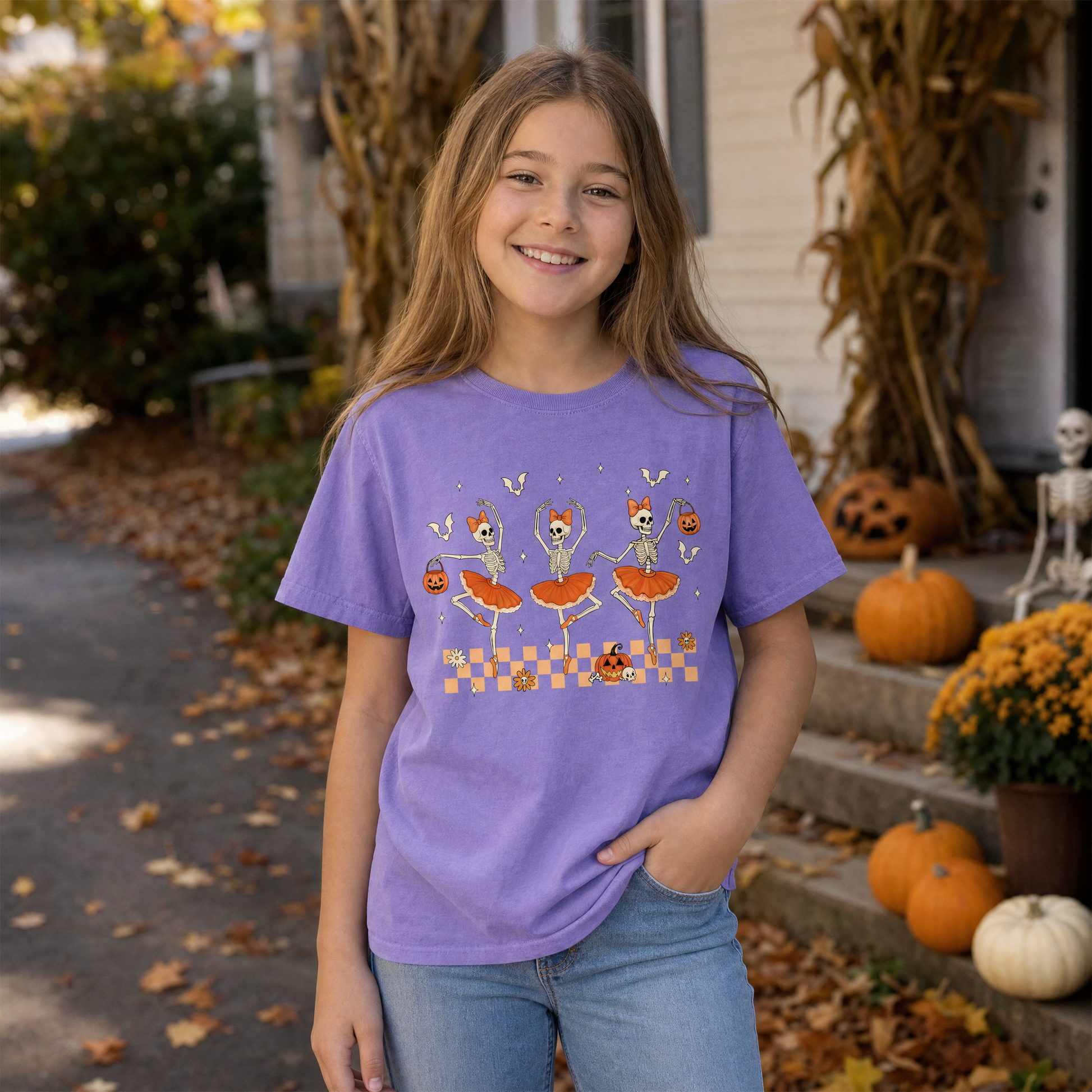 Model wearing the Ballerina Skeletons youth comfort colors tee in Violet