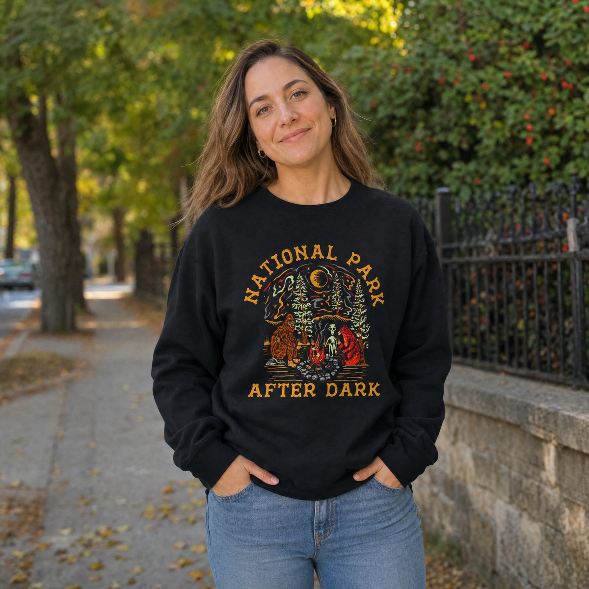 Model wearing the Bigfoot Bear Alien Campfire sweatshirt in Black