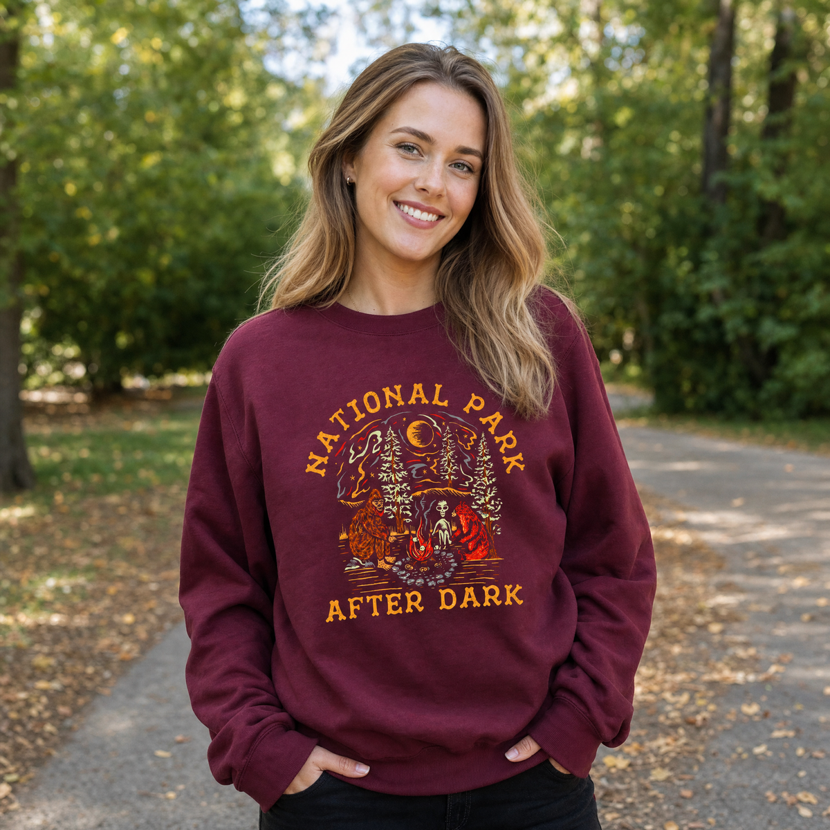 Model wearing the Bigfoot Bear Alien Campfire sweatshirt in Maroon