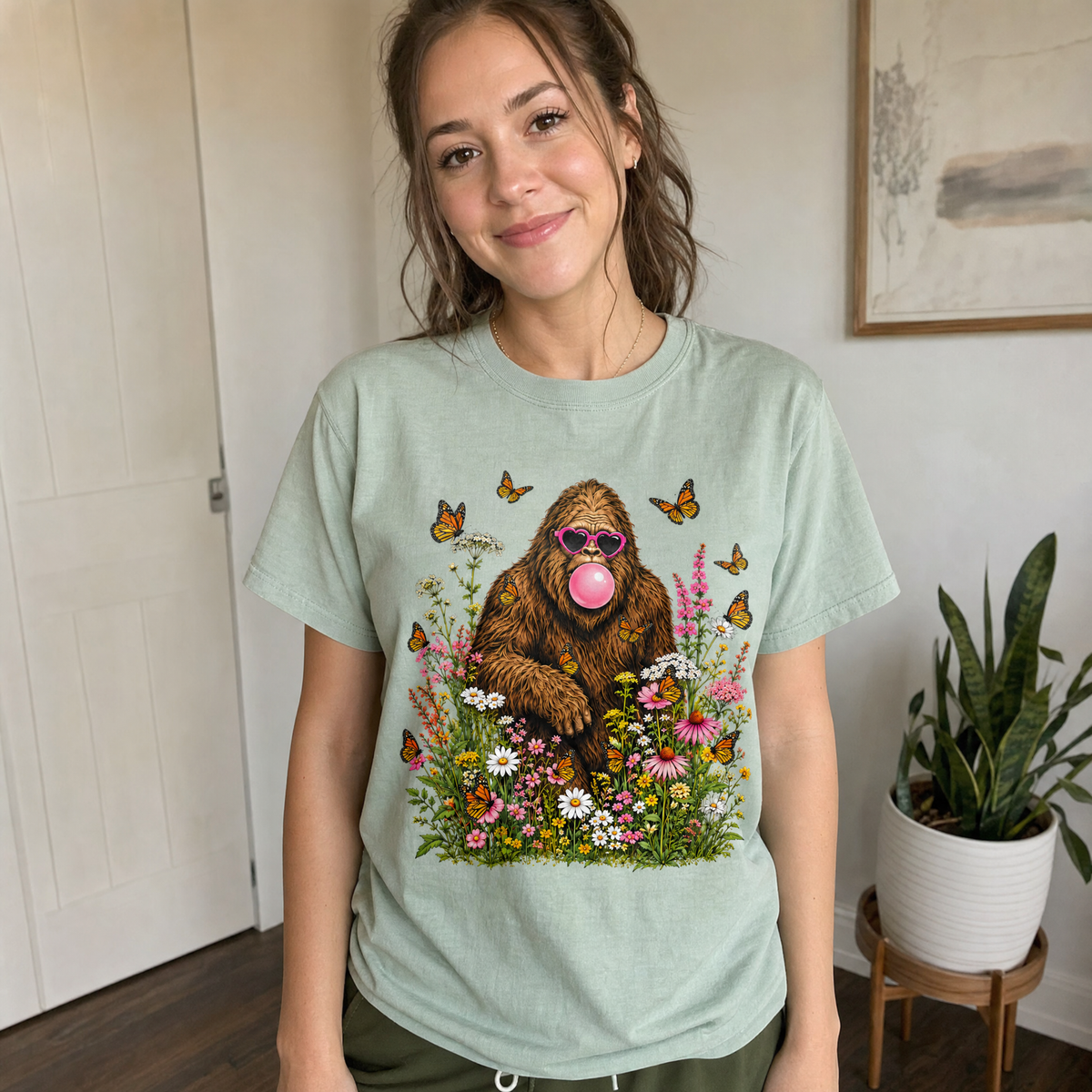 Model wearing the Bigfoot Bubble Gum comfort colors tee in Bay
