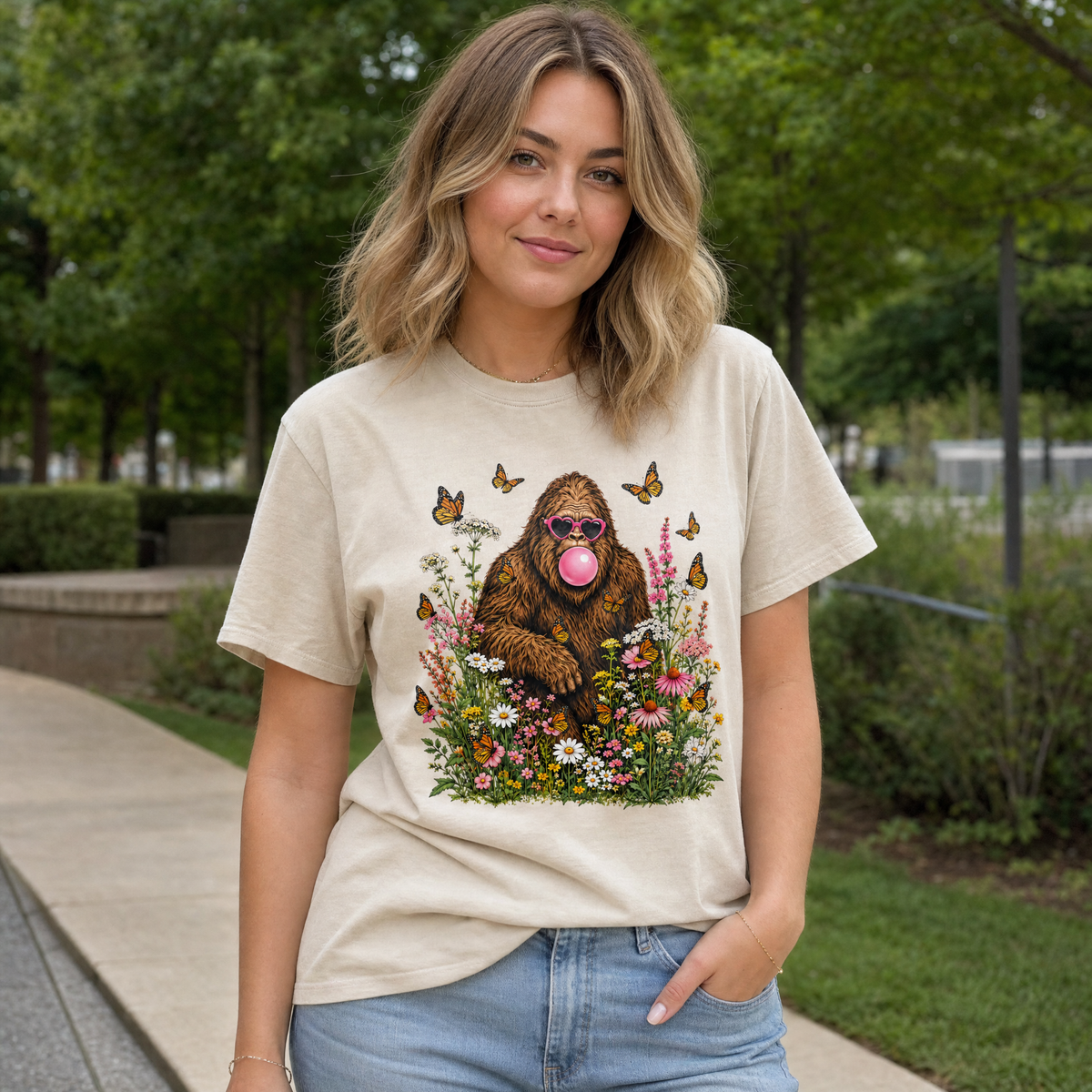 Model wearing the Bigfoot Bubble Gum comfort colors tee in Ivory, lifestyle image 1