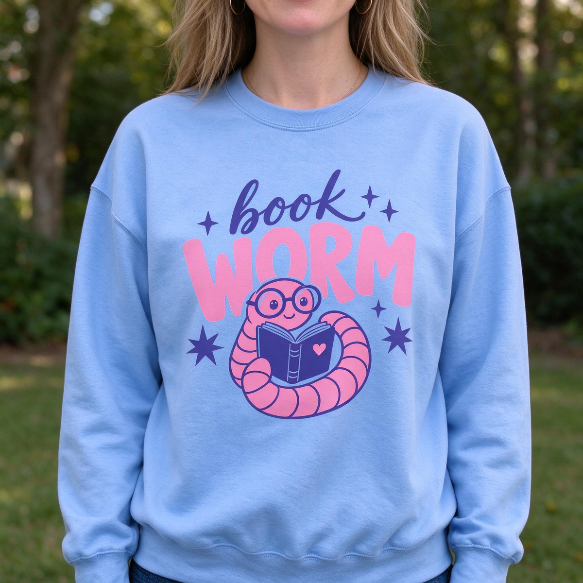 Model wearing the Book Worm sweatshirt in Carolina Blue
