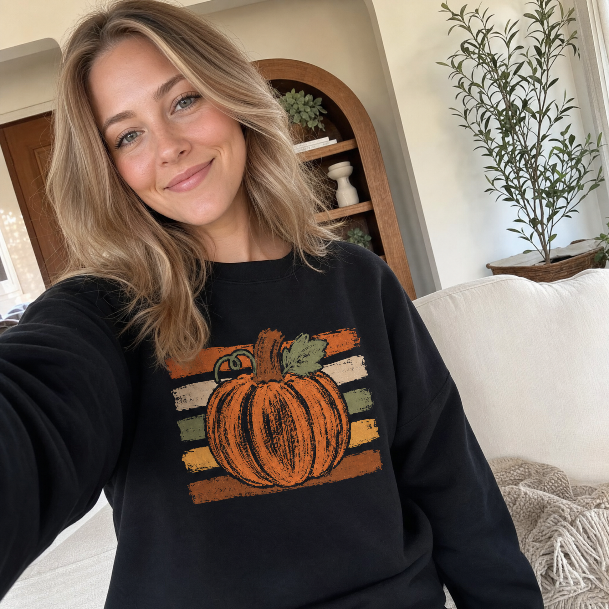 Model wearing the Brushstroke Pumpkin sweatshirt in Black