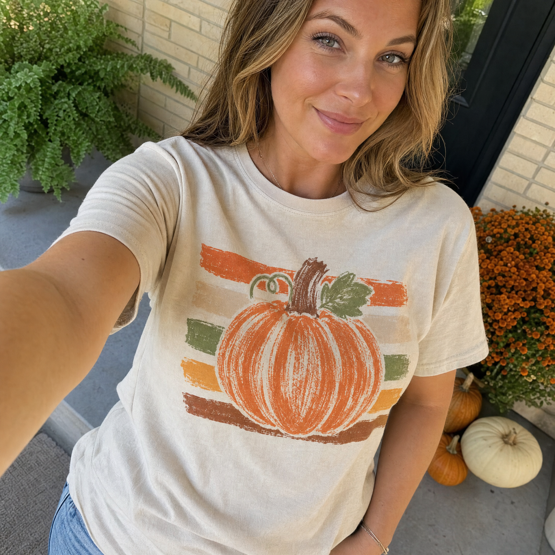 Model wearing the Brushstroke Pumpkin comfort colors tee in Ivory