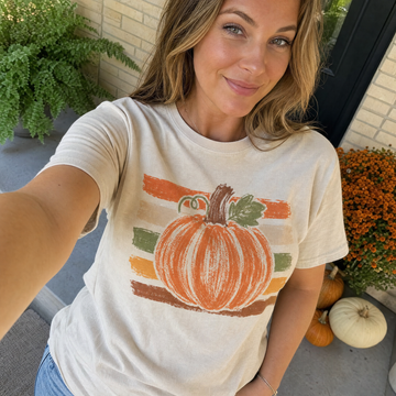 Model wearing the Brushstroke Pumpkin comfort colors tee in Ivory