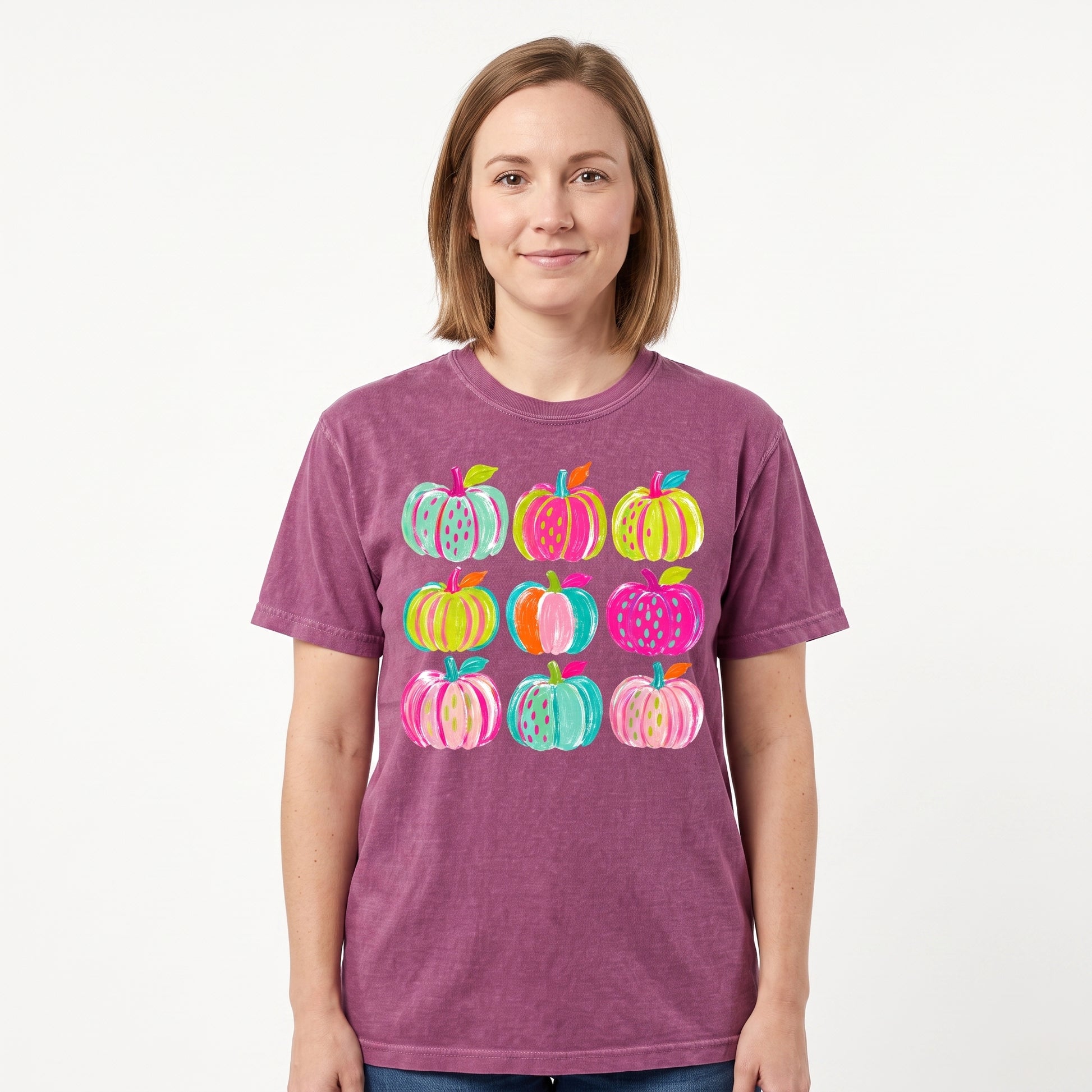 Model wearing the Brushstroke Pumpkins comfort colors tee in Berry