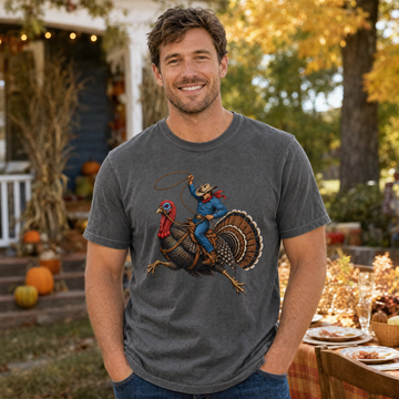 Model wearing the Cowboy Riding Turkey comfort colors tee in Pepper, lifestyle image 1