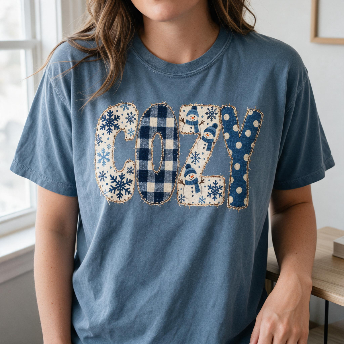 Model wearing the Cozy Snowmen comfort colors tee in Blue Jean