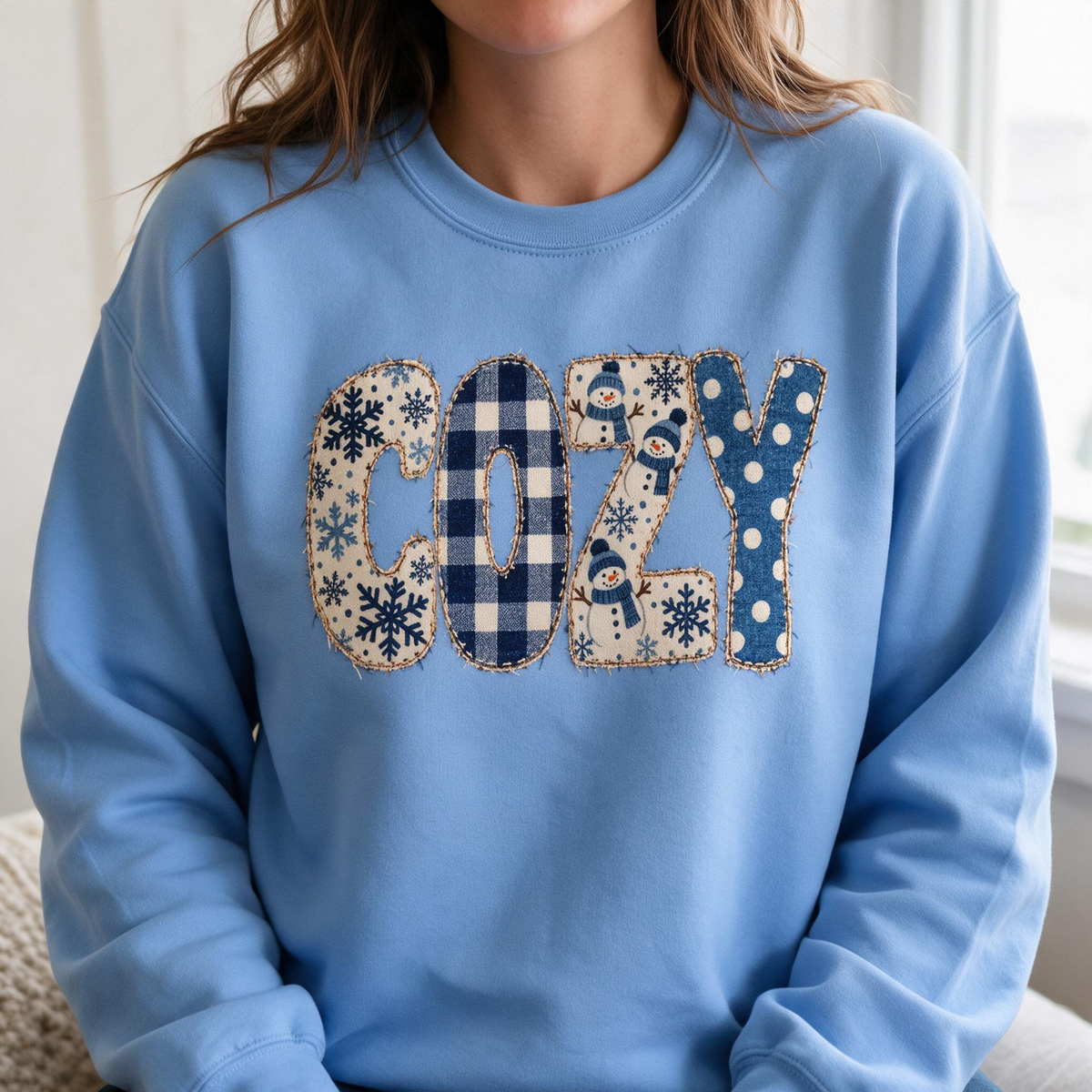 Model wearing the Cozy Snowmen sweatshirt in Carolina Blue, lifestyle image 1