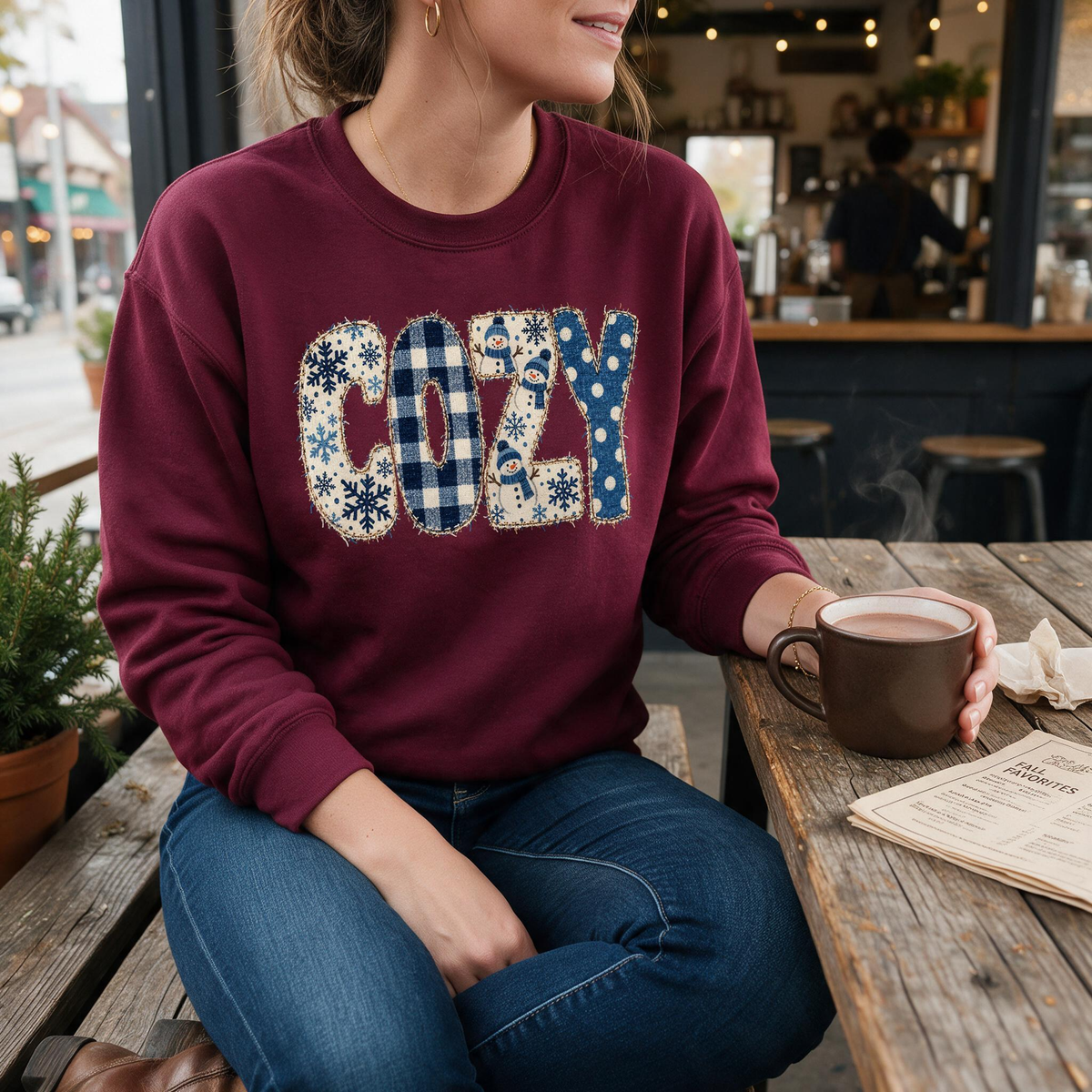 Model wearing the Cozy Snowmen sweatshirt in Maroon
