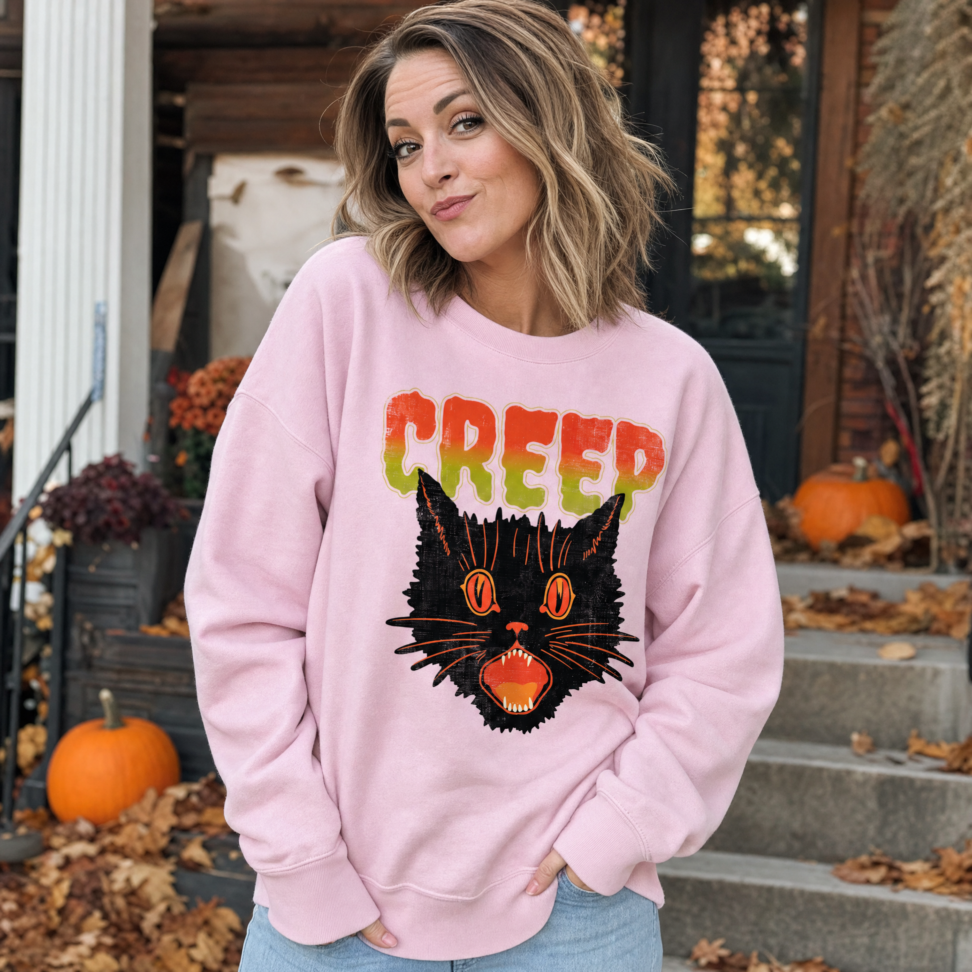 Model wearing the Creep Black Cat sweatshirt in Light Pink