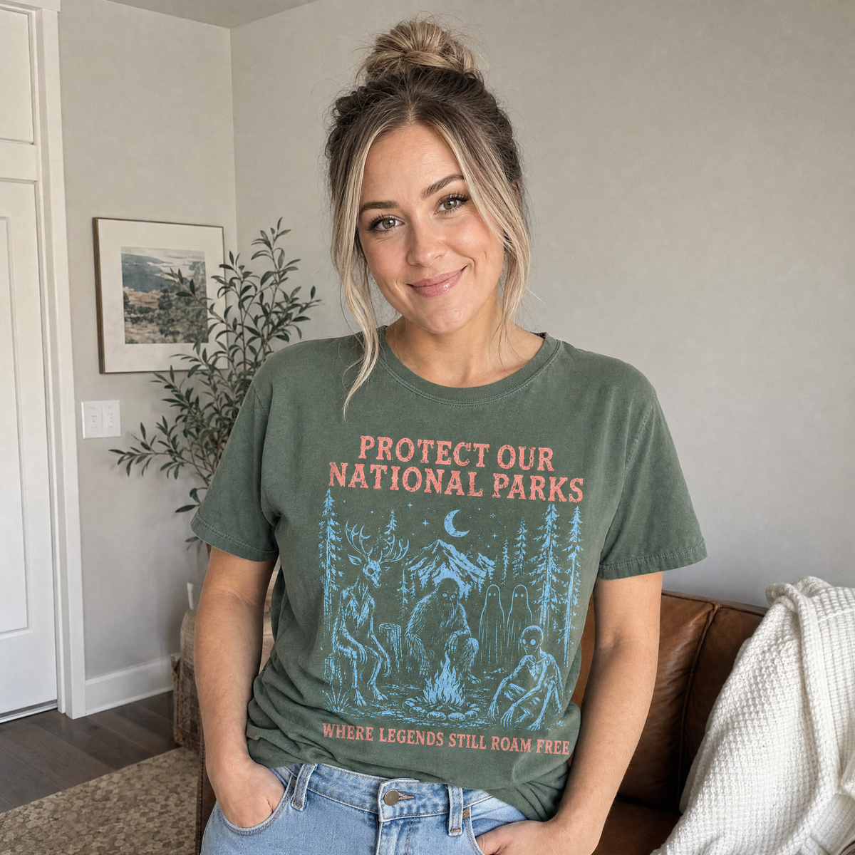 Model wearing the Cryptid Campfire comfort colors tee in Moss