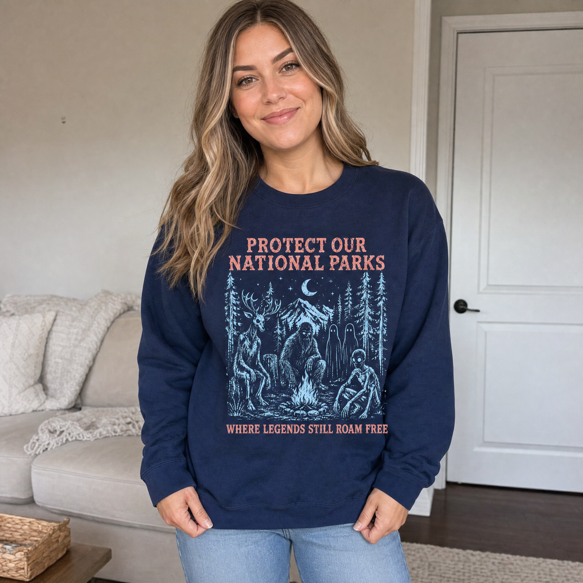 Model wearing the Cryptid Campfire sweatshirt in Navy, lifestyle image 1