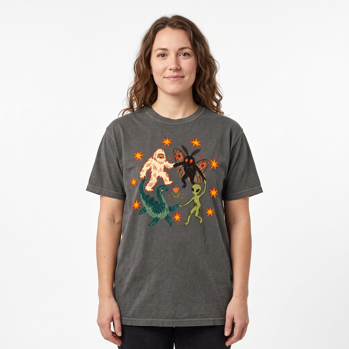 Model wearing the Cryptid Dance Party comfort colors tee in Pepper, cover image 1