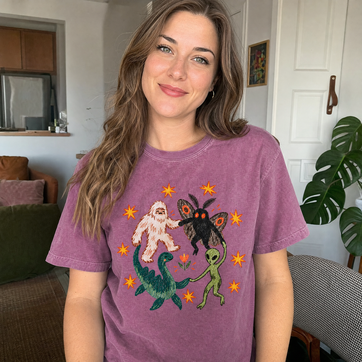 Model wearing the Cryptid Dance Party comfort colors tee in Berry