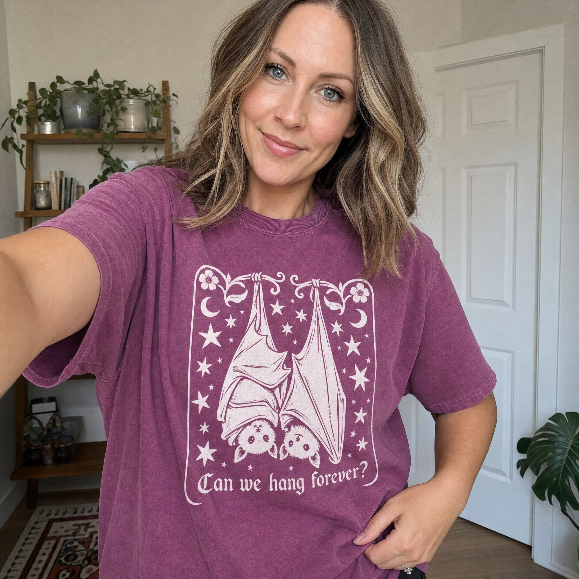 Model wearing the Cute Hanging Bats comfort colors tee in Berry