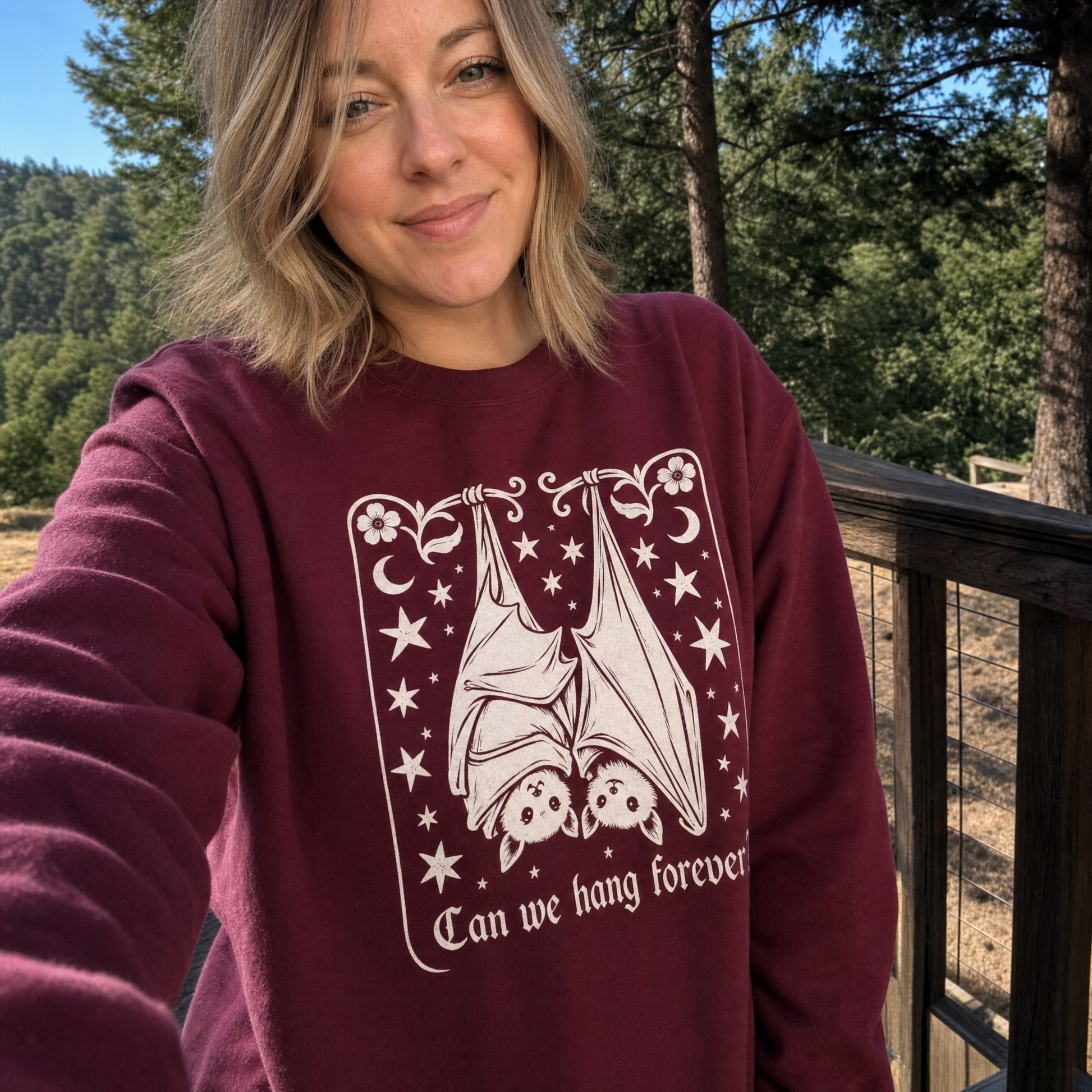 Model wearing the Cute Hanging Bats sweatshirt in Maroon