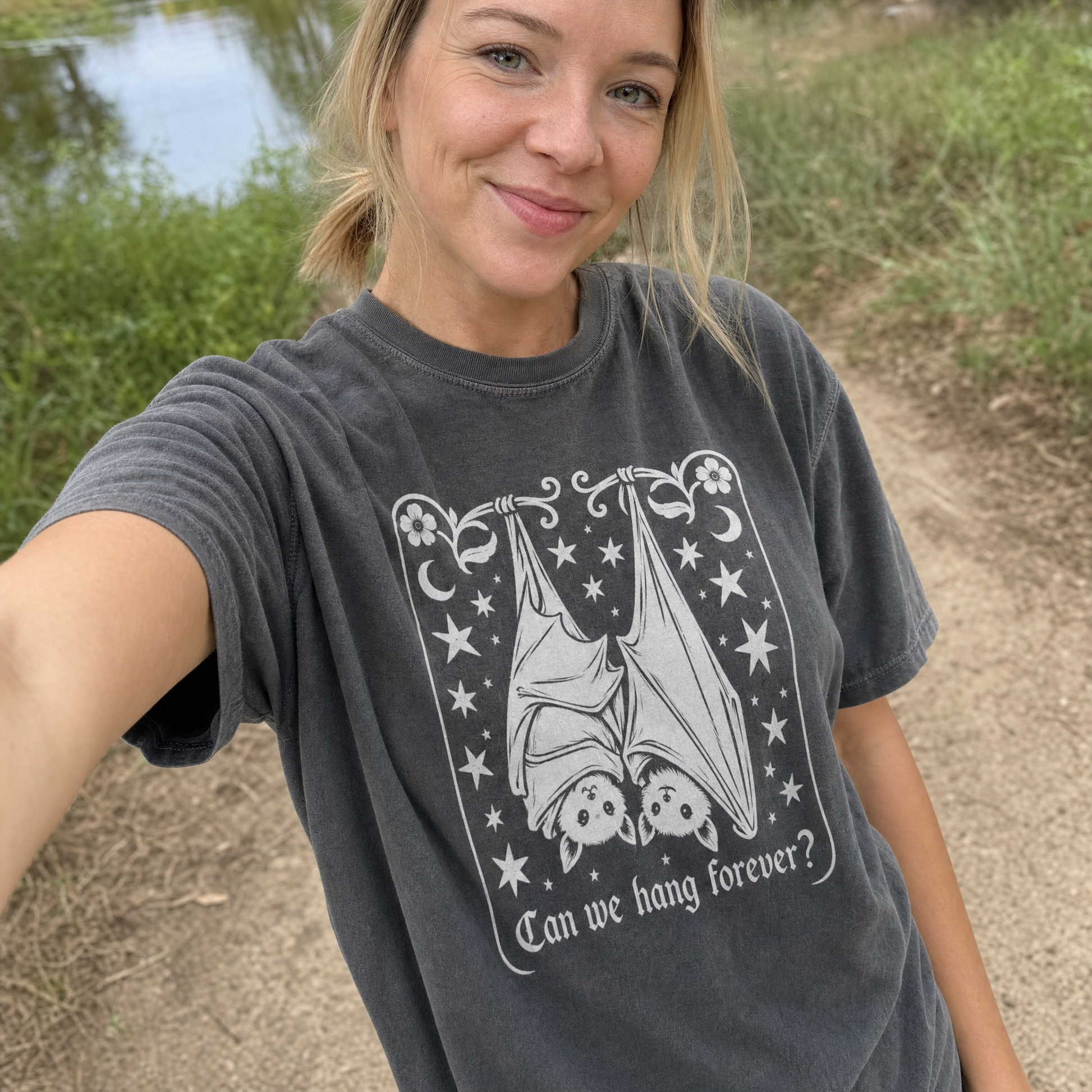 Model wearing the Cute Hanging Bats comfort colors tee in Pepper, lifestyle image 1