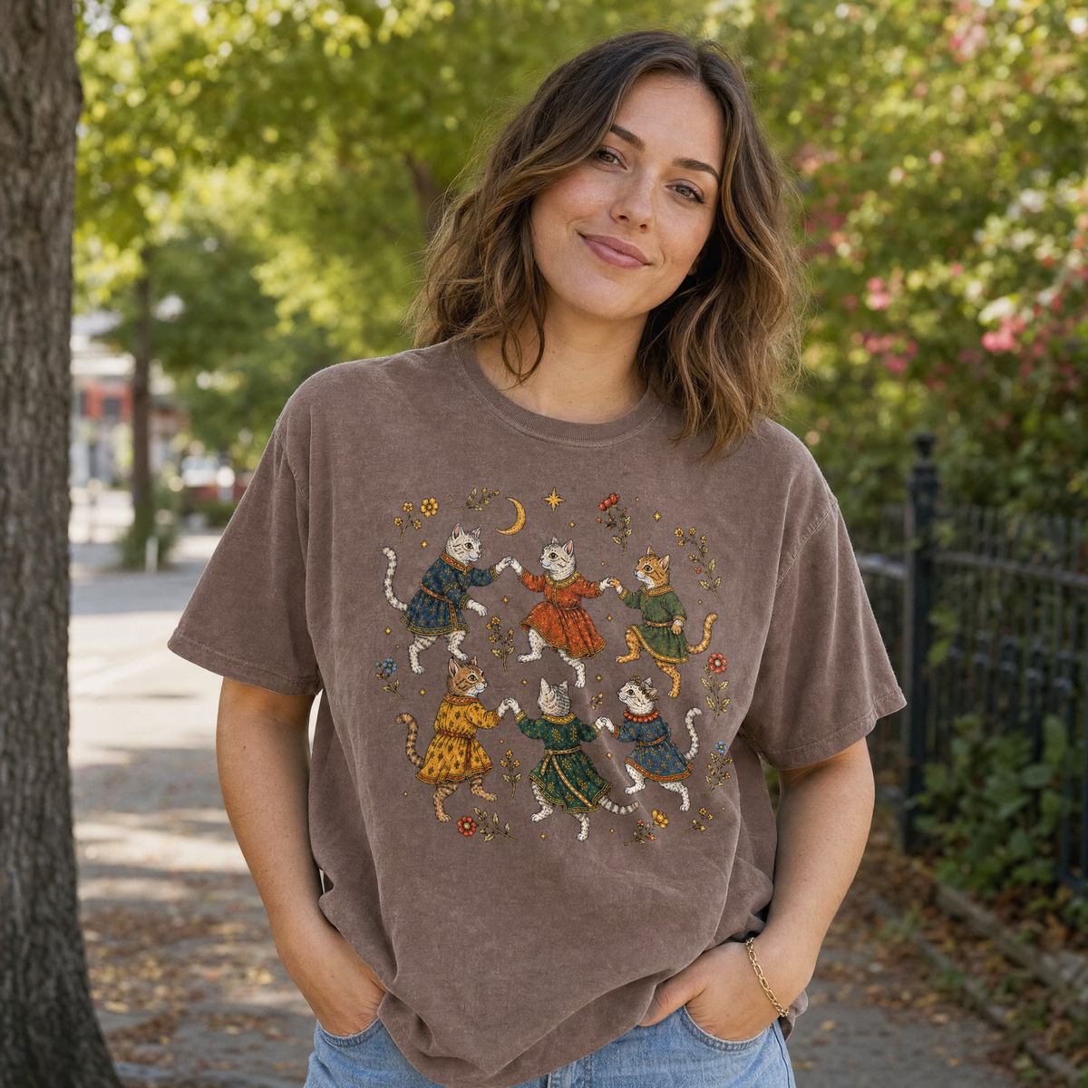 Model wearing the Dancing Medieval Cats comfort colors tee in Espresso