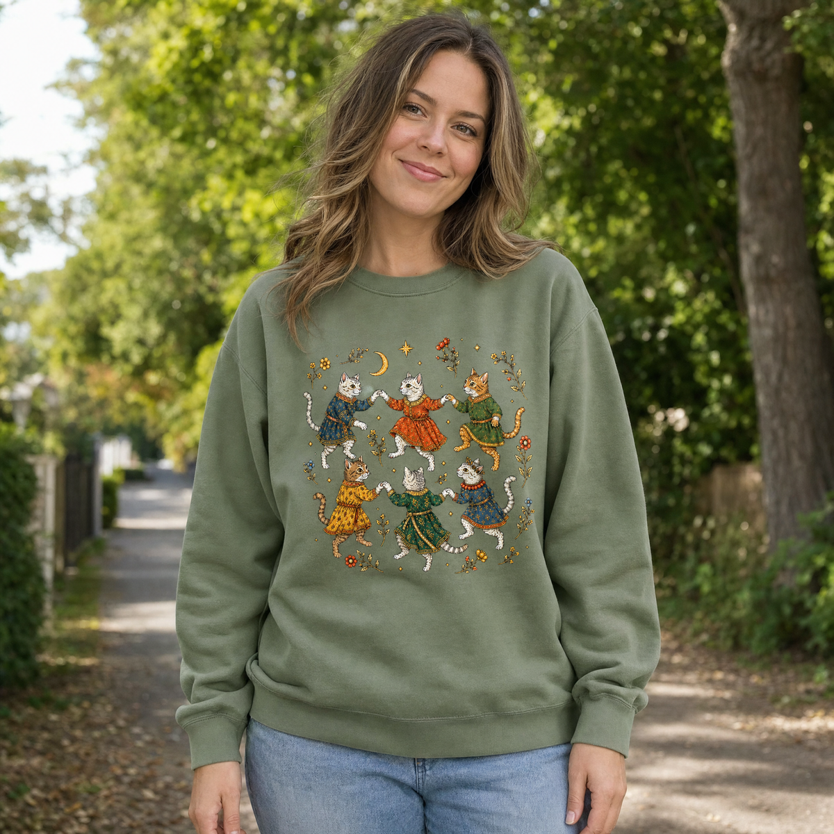 Model wearing the Dancing Medieval Cats sweatshirt in Military Green