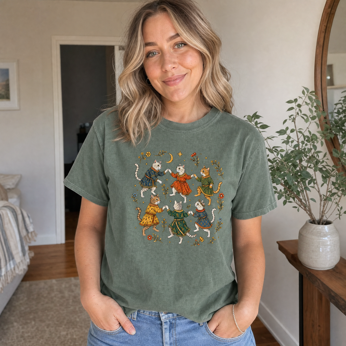 Model wearing the Dancing Medieval Cats comfort colors tee in Moss