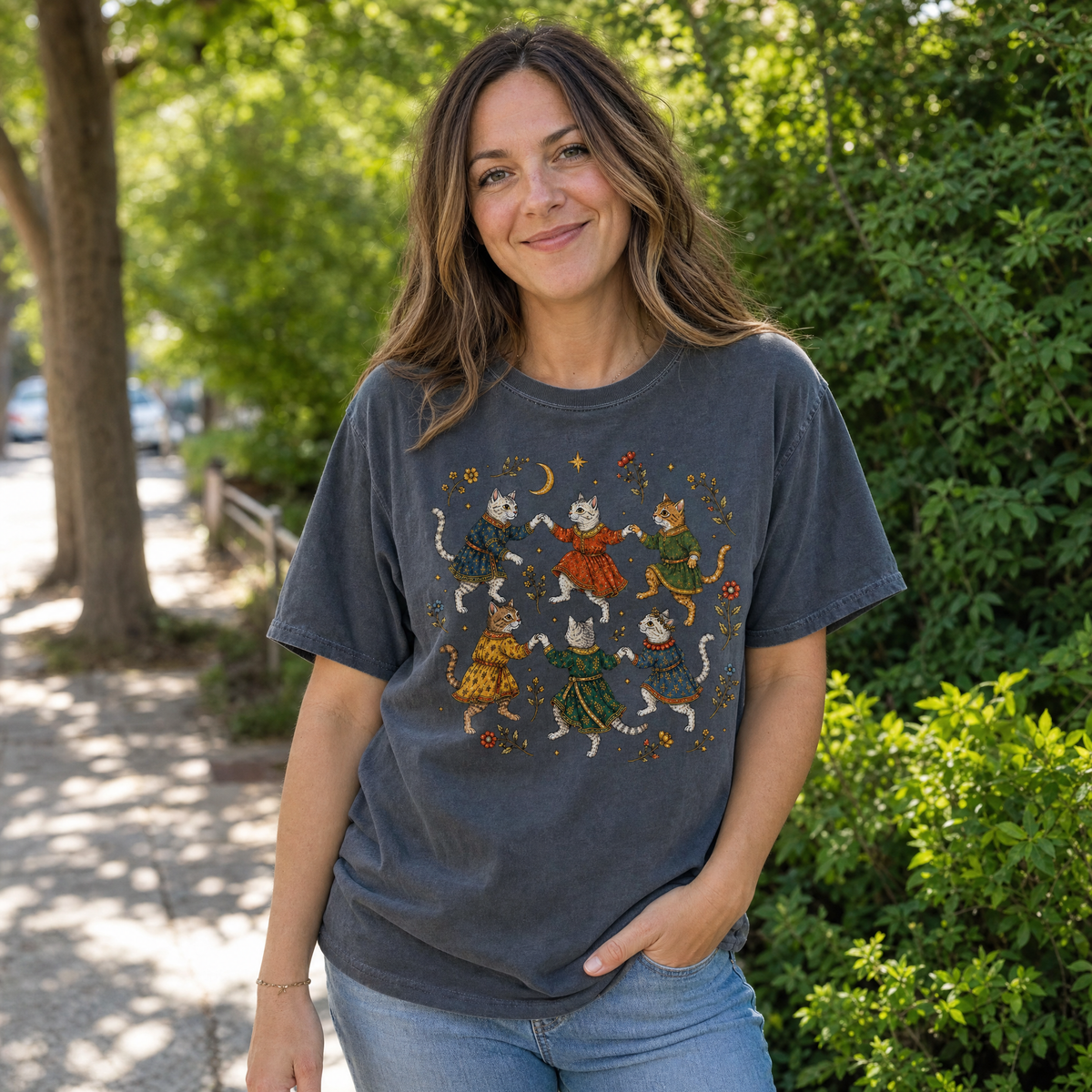 Model wearing the Dancing Medieval Cats comfort colors tee in Pepper