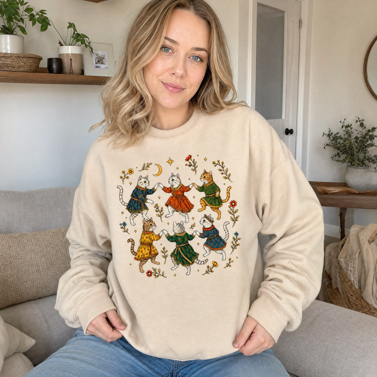 Model wearing the Dancing Medieval Cats sweatshirt in Sand