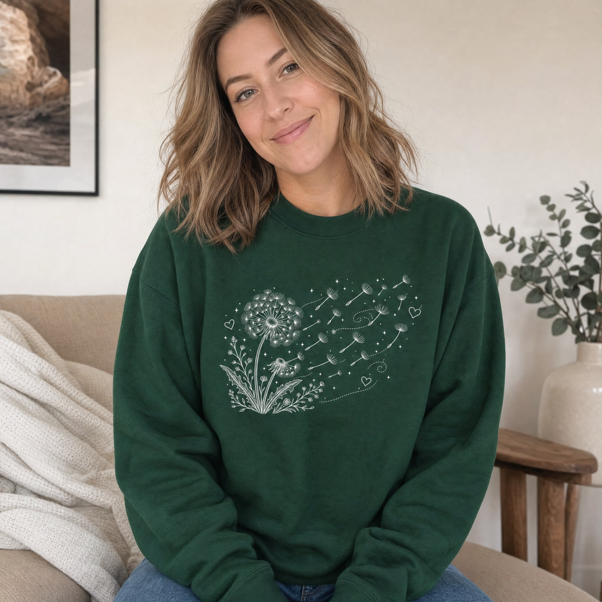 Model wearing the Dandelion Blowing in the Wind sweatshirt in Forest Green