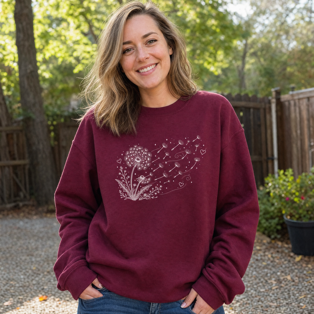 Model wearing the Dandelion Blowing in the Wind sweatshirt in Maroon, lifestyle image 1