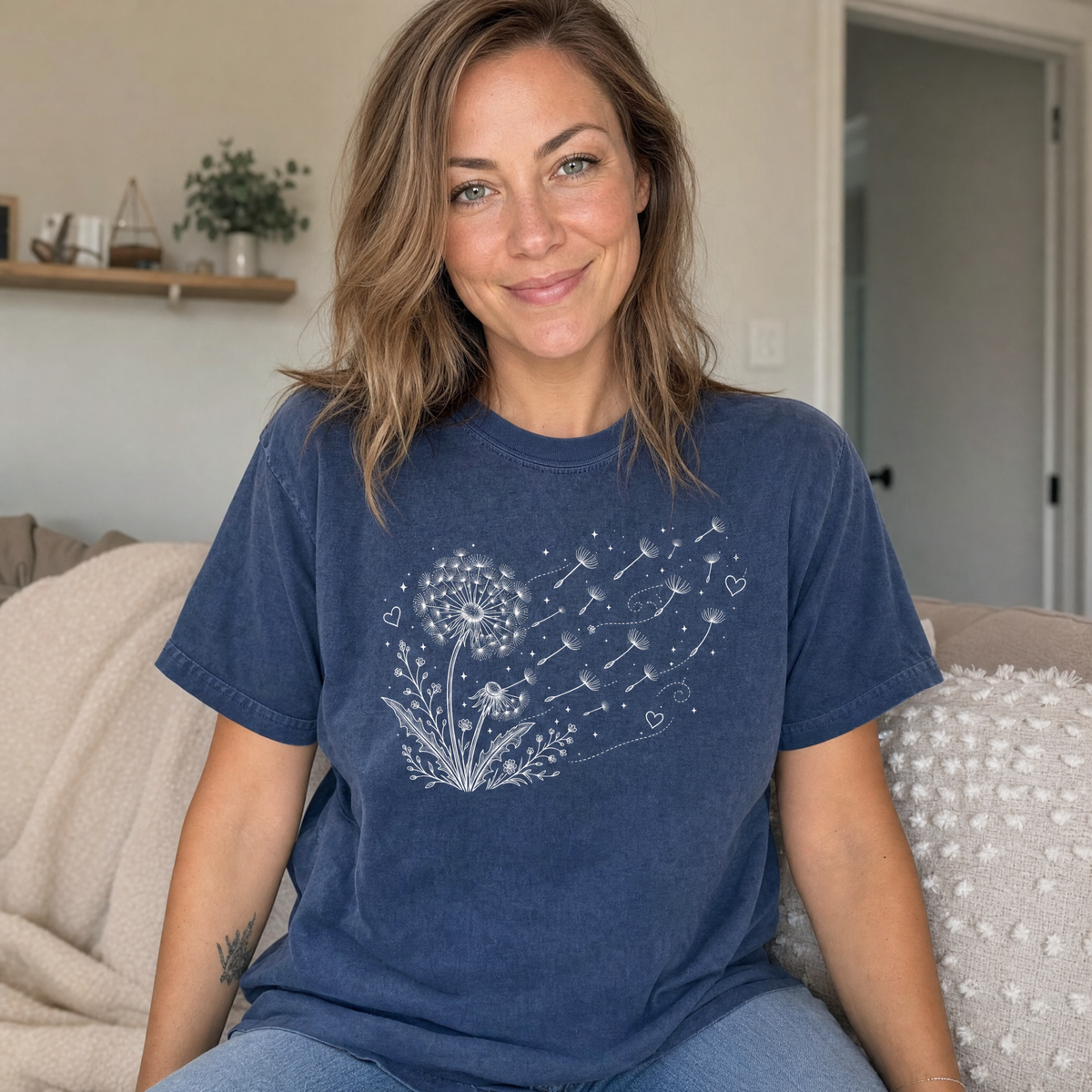 Model wearing the Dandelion Blowing in the Wind comfort colors tee in Midnight