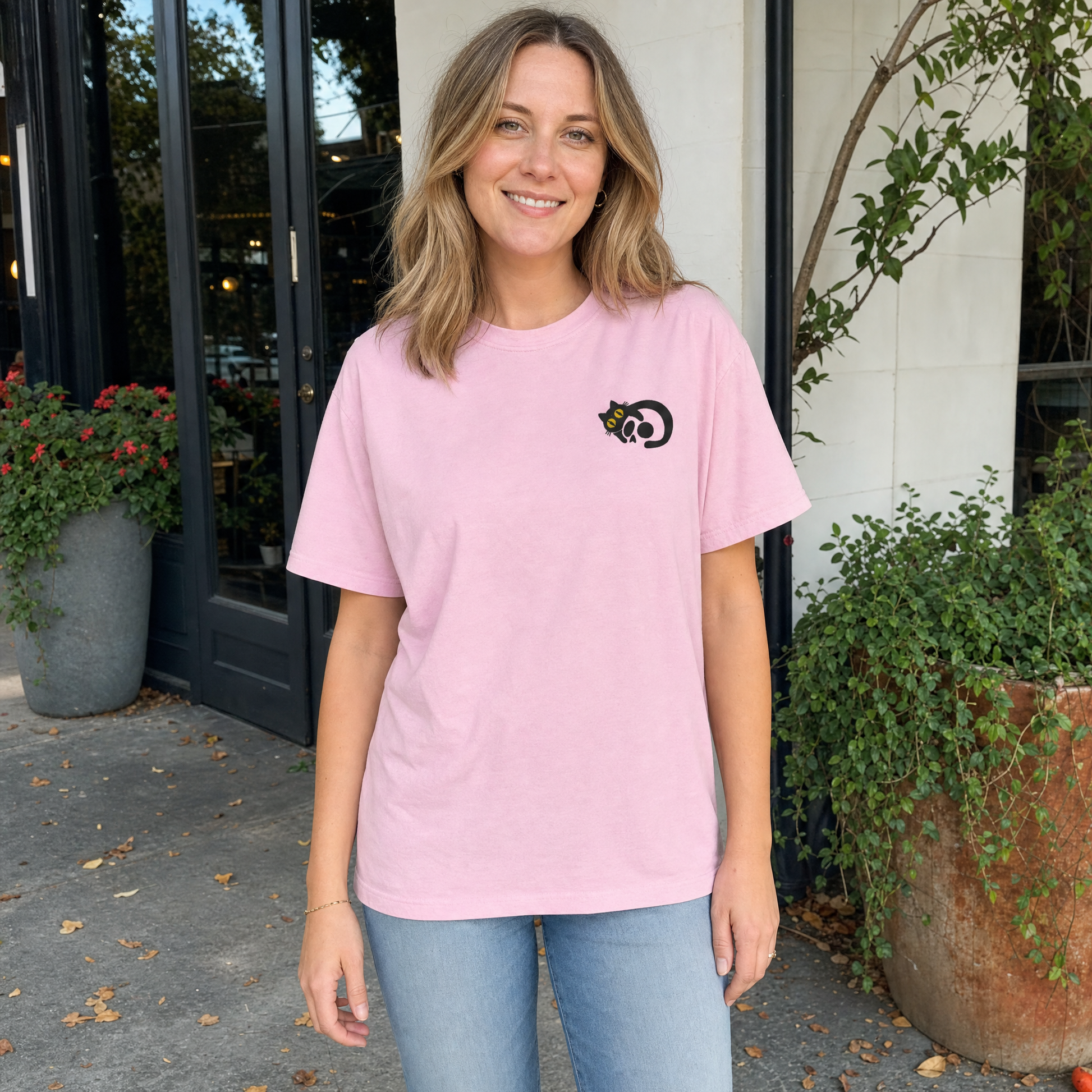 Model wearing the Black Cat Skull comfort colors tee in Blossom, cover image 1