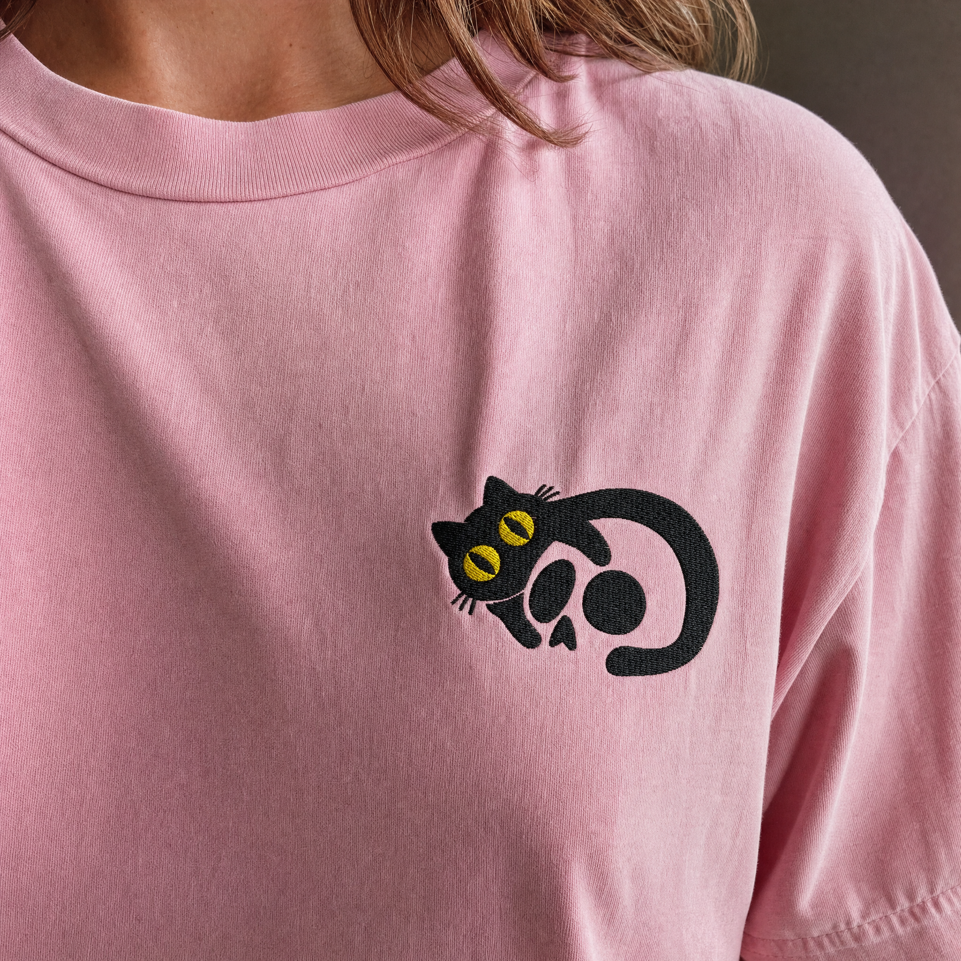 Model wearing the Black Cat Skull comfort colors tee in Blossom, lifestyle image 1