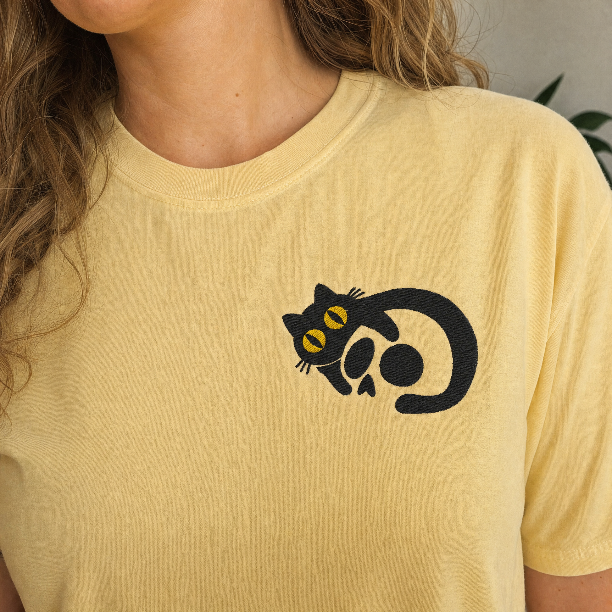 Model wearing the Black Cat Skull comfort colors tee in Butter, lifestyle image 2