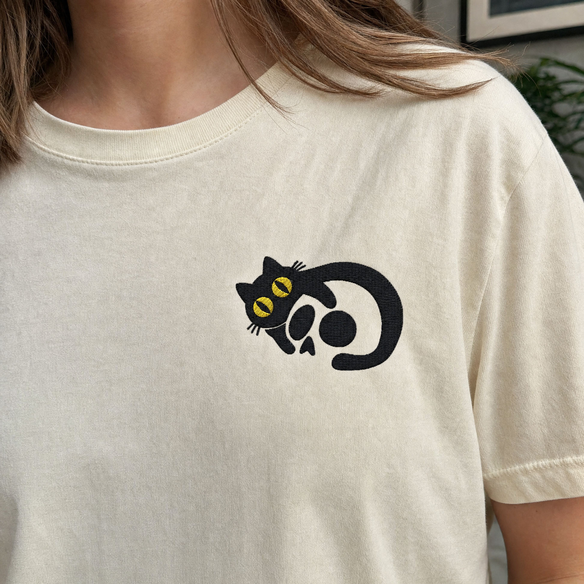 Model wearing the Black Cat Skull comfort colors tee in Ivory, lifestyle image 2