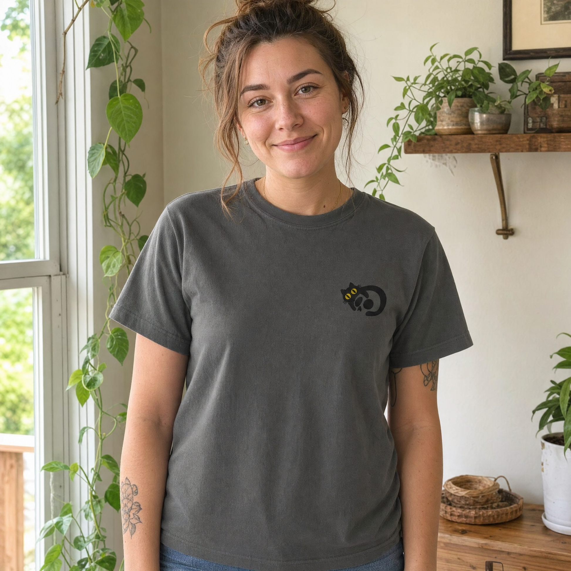 Model wearing the Black Cat Skull comfort colors tee in Pepper, lifestyle image 1