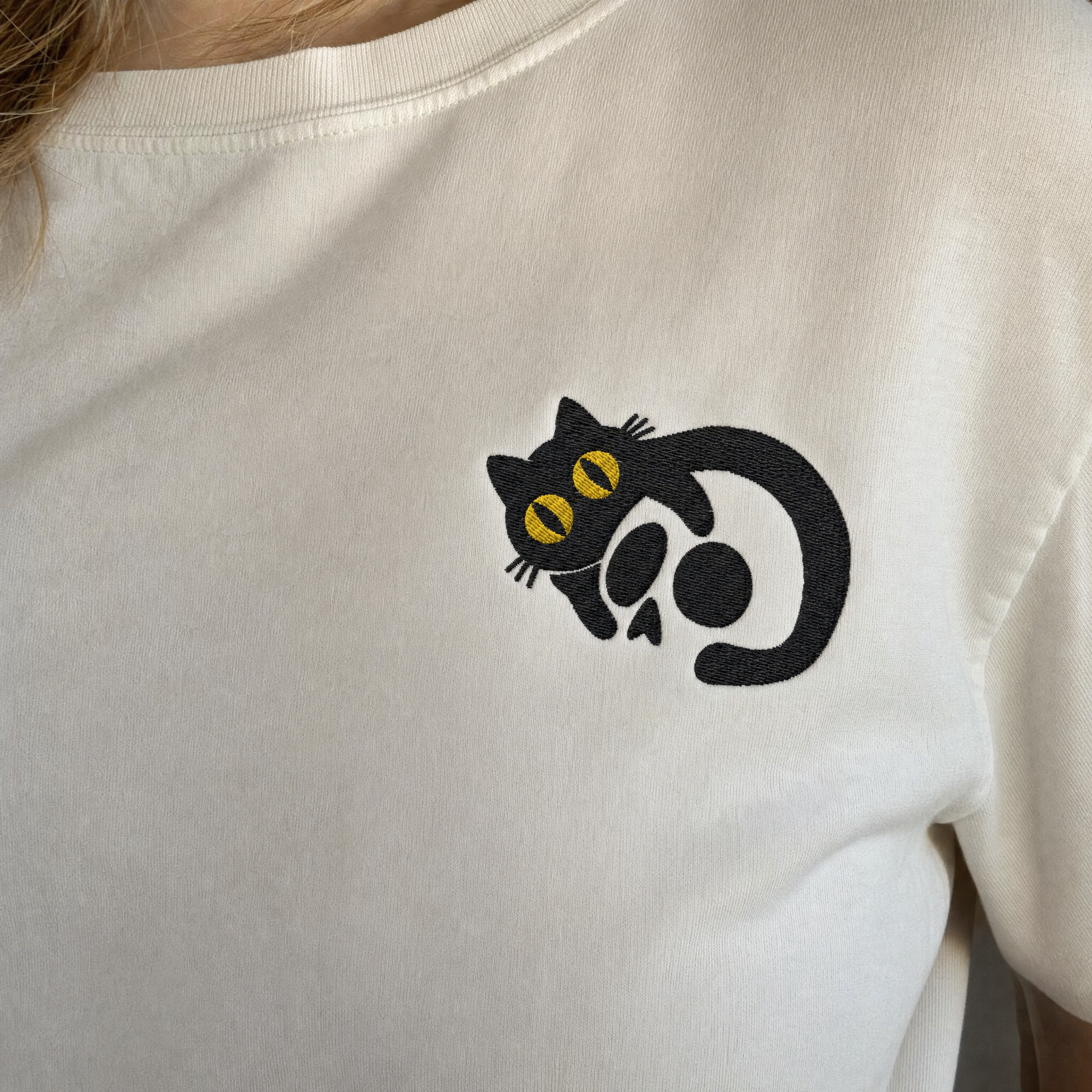 Model wearing the Black Cat Skull comfort colors tee in White, lifestyle image 2