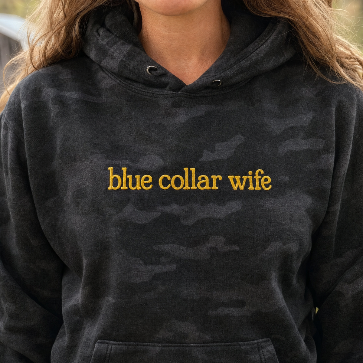 Model wearing the Blue Collar Wife heavyweight hoodie in Black Camo, lifestyle image 2