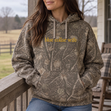 Model wearing the Blue Collar Wife heavyweight hoodie in Light Tree Camo, lifestyle image 2