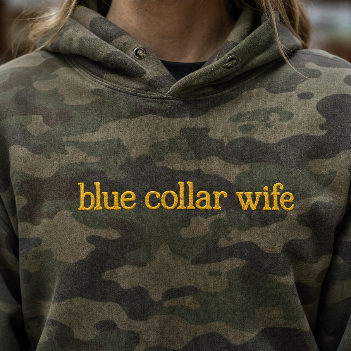 Model wearing the Blue Collar Wife heavyweight hoodie in Green Camo, lifestyle image 2