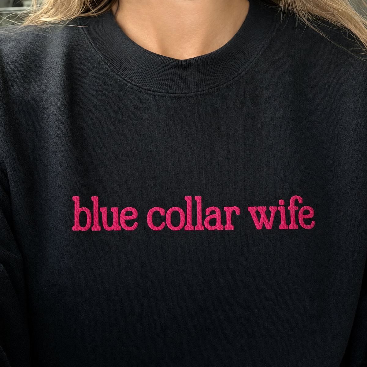 Model wearing the Blue Collar Wife sweatshirt in Black, lifestyle image 1