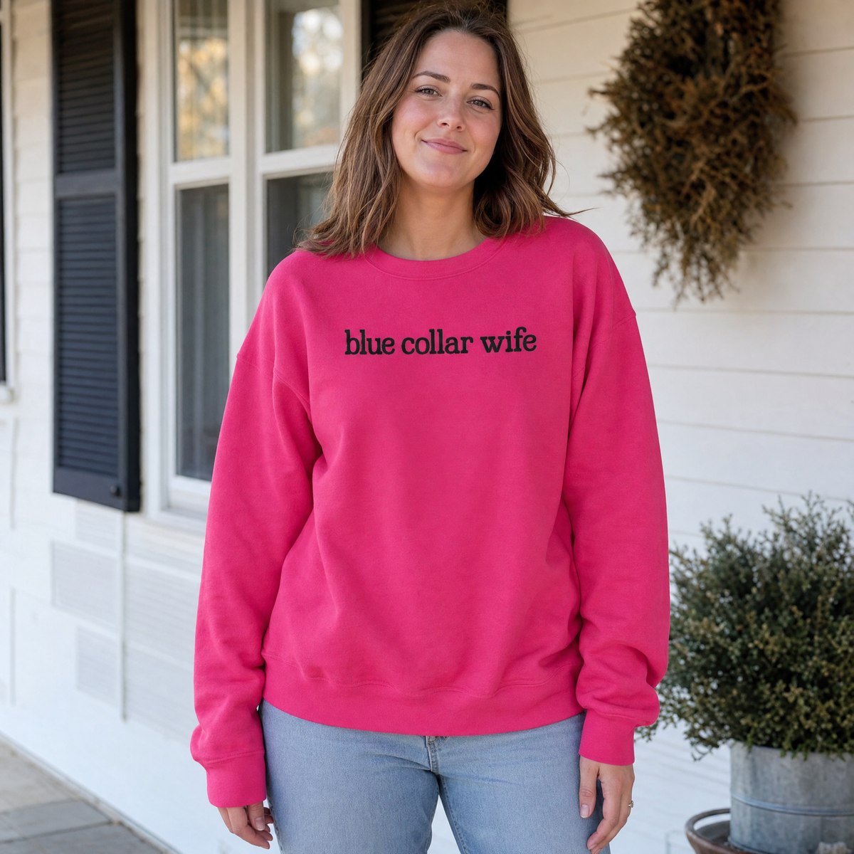 Model wearing the Blue Collar Wife sweatshirt in Heliconia, lifestyle image 1