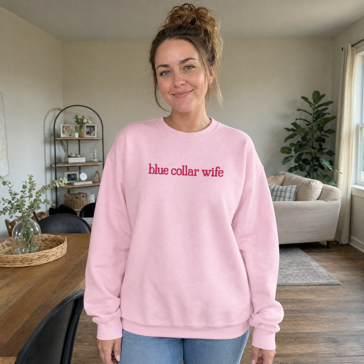 Model wearing the Blue Collar Wife sweatshirt in Light Pink, lifestyle image 1