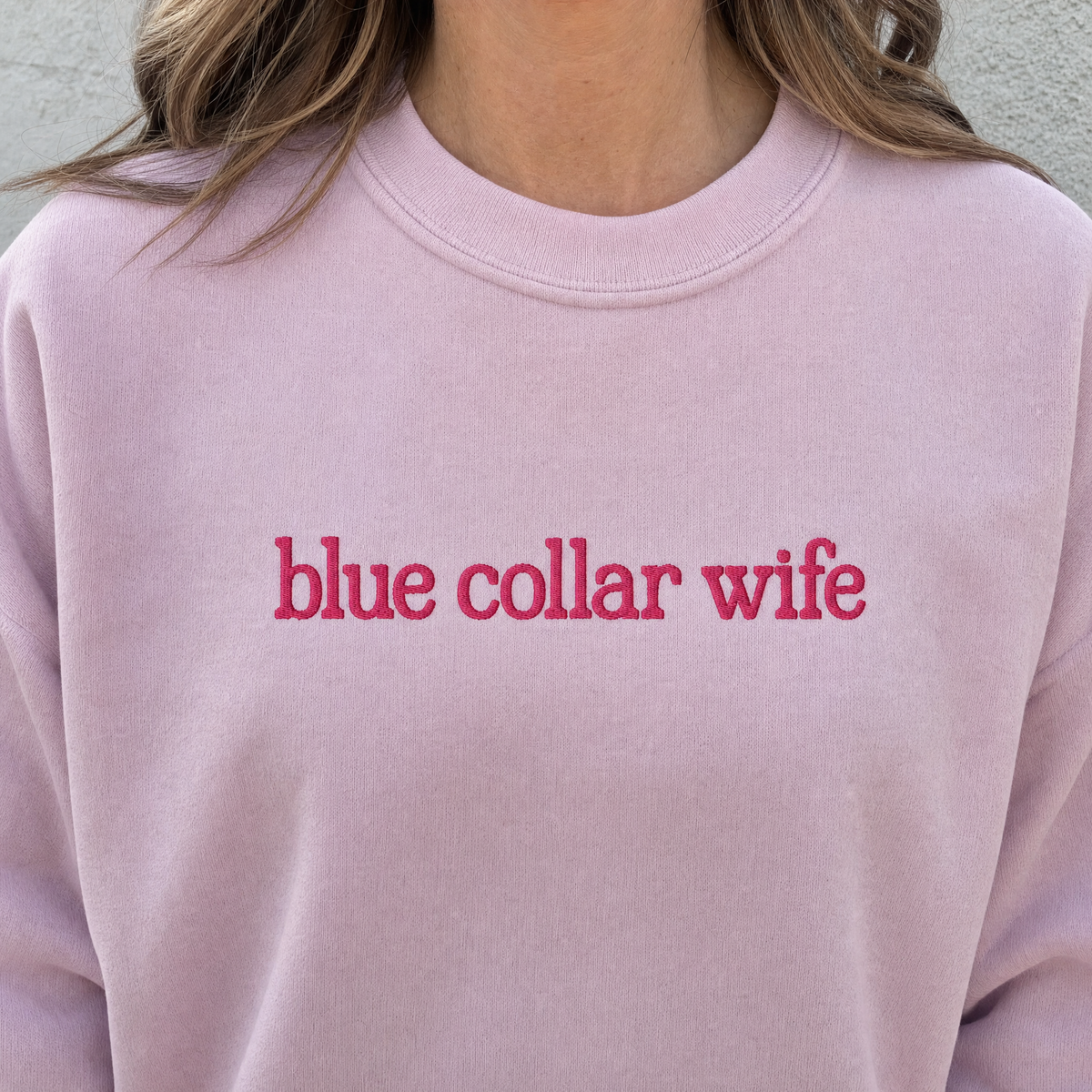 Model wearing the Blue Collar Wife sweatshirt in Light Pink, lifestyle image 2
