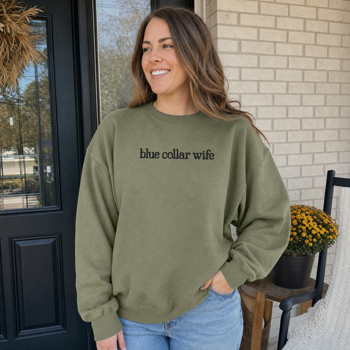 Model wearing the Blue Collar Wife sweatshirt in Military Green, lifestyle image 1