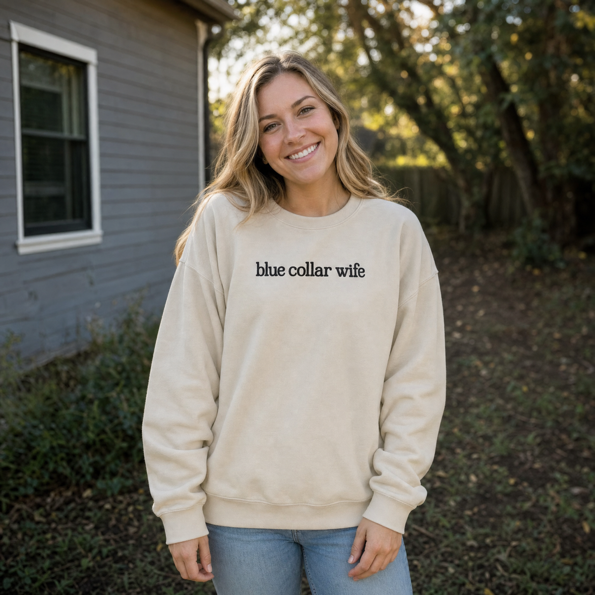 Model wearing the Blue Collar Wife sweatshirt in Sand, lifestyle image 1